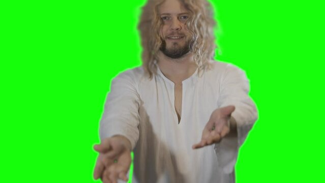 Jesus Christ shows scars on hands stigmata from wounds after crucifixion on a green background