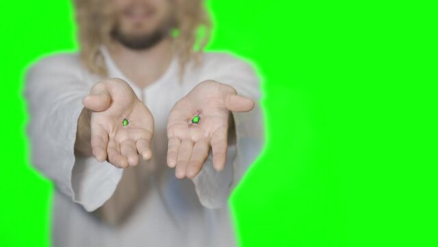 Jesus Christ shows scars on hands stigmata from wounds after crucifixion on a green background