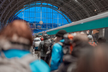 Crowd of people is rushing towards the first morning train from Bergen to Oslo, visible people,...