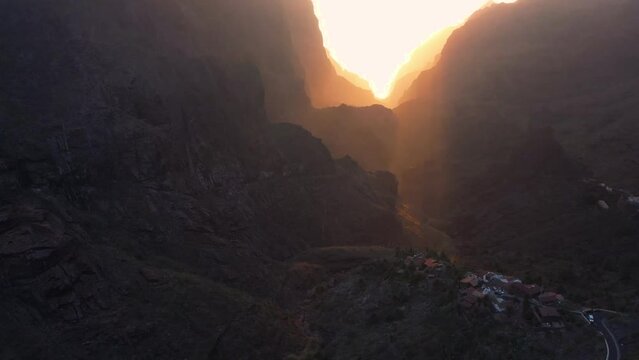 Aerial sunset of Masca valley. Asphalt road and cars on steep volcanic slopes of Tenerife Canary Islands