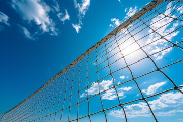 Outdoor beach volleyball with blue sky net and ocean for competition or recreation in summer - obrazy, fototapety, plakaty