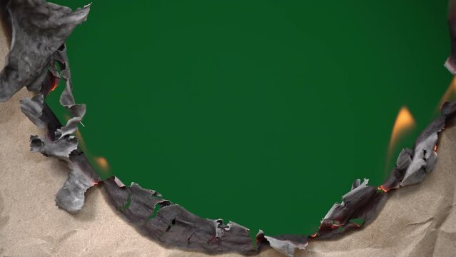 Old craft paper burns leaving a green background, chromakey. The paper burns with a bright flame. The brown leaf burns leaving a green color.
