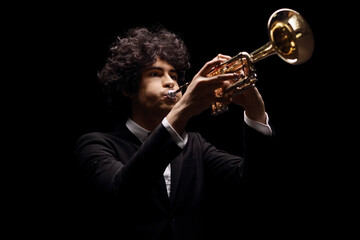 Young man in a black suit playing a trumpet
