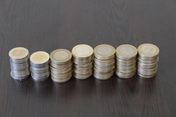 turkish coins lined up on black background.