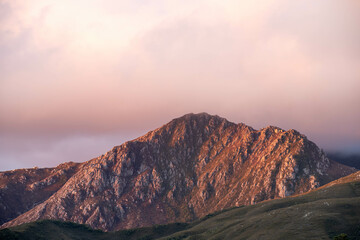clouds over mountains over the water in a national park and beautiful rock mountain above the ocean in a national park