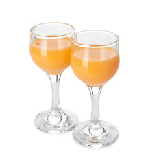 Tasty tangerine liqueur in glasses isolated on white