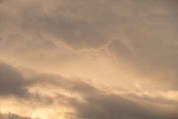Dramatic stormy sky in evening light as the sun is setting, as a nature background
