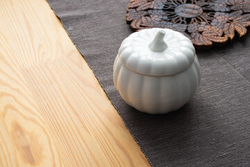 Ceramic vase in the shape of a pumpkin on the table. Kitchen decor