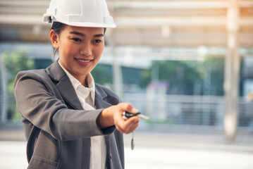 Civil women engineer wear safety white hard hat Hands using remote control car key. Close up hands...