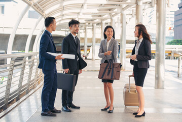 Portrait Group of businesspeople arms crossed smiling look at camera in modern city background. Happy Businessman, businesswoman teams partnership. Business people teams positive teamwork standing.