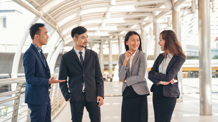 Portrait Group of businesspeople arms crossed smiling look at camera in modern city background. Happy Businessman, businesswoman teams partnership. Business people teams positive teamwork standing.