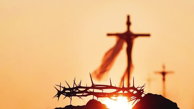The cross and crown of thorns symbolizing the passion, sacrifice and suffering of Jesus Christ, and the red sunset and Passion Week and Lenten Easter background
