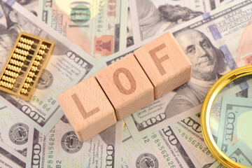 There are blocks with LOF letters printed on the US dollar props