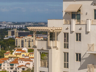 Aerial close up view of roof top terrace in a luxury apartment condo building with pergola sun shade protecting the residents from the sun