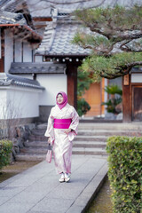 Fototapeta na wymiar Travel, muslim travel, Arashiyama, Asian female Muslim tourist in traditional japanese kimonos walking and travel to Tenryu-ji temple and Arashiyama city, Kyoto, Arashiyama, Japan.