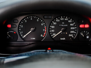 Close-up View of a Car Dashboard with Illuminated Gauges