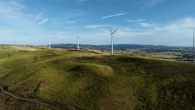 Aerial rising shot in front of windmills in the uplands of San Francisco, USA