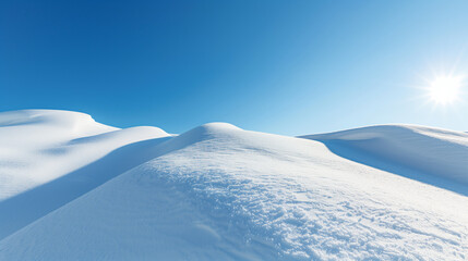 Pristine snow-covered hills with a clear blue sky and radiant sun, ideal for winter backgrounds or seasonal concept designs, with ample copy space