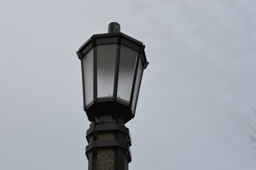 Fototapeta na wymiar street city lamp in the park with tree branches in the background DSLR photo
