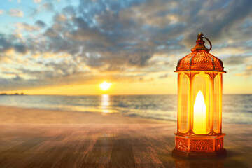 Arabic lantern on sea beach at beautiful sunset sky with cloud, Ramadan kareem background - 739692796