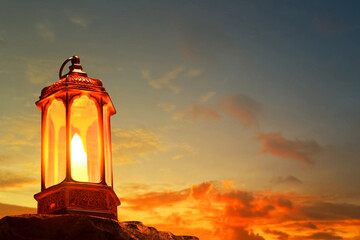 Arabic lantern on top rock mountain at beautiful sunset sky with cloud, Ramadan kareem background - 739694725