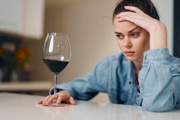 Depressed Woman Drinking Wine Alone: A Portrait of Sadness and Loneliness.