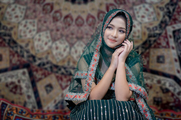 Fototapeta premium Beautiful Arabic Muslim woman the Arabian beauty wearing green Hijab clothes. Pretty Muslim girl. Portrait fashionable of Islamic female.