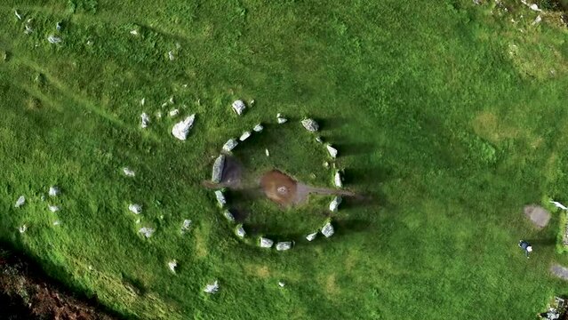 Top down aerial shot looking down on the Drombeg Stone Circle rotating around in a circle in County Cork, Ireland