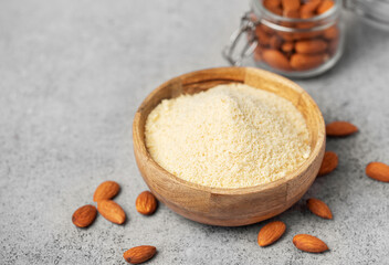 Fresh almond flour in a  bowl and almonds