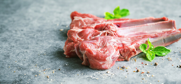 Raw lamb ribs on marble background