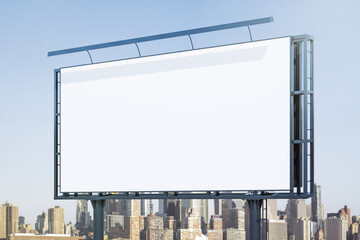 Obraz premium Blank white billboard on city buildings background at daytime, perspective view. Mockup, advertising concept
