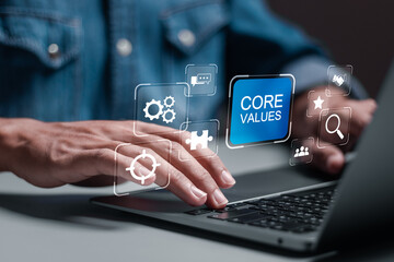 Core values responsibility ethics goals company concept. Person using laptop with core values icons on virtual screen. - obrazy, fototapety, plakaty