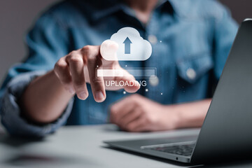 Cloud upload concept. uploading business information. Person use laptop with cloud upload bar on virtual screen.