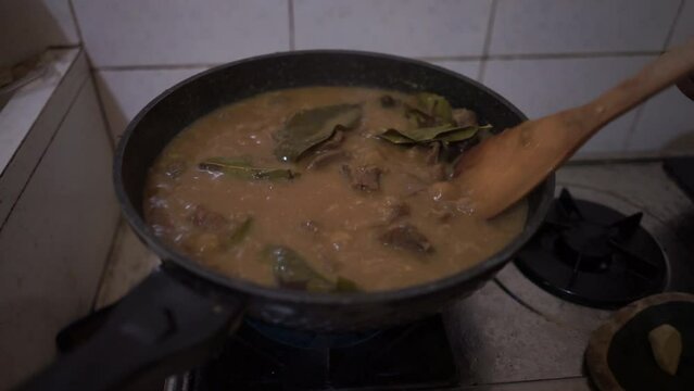 Cooking Indonesian rendang daging or beef stew originally from Minang Padang West Sumatra