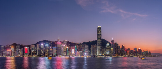 Panorama of Victoria harbor of Hong Kong city at dusk - obrazy, fototapety, plakaty