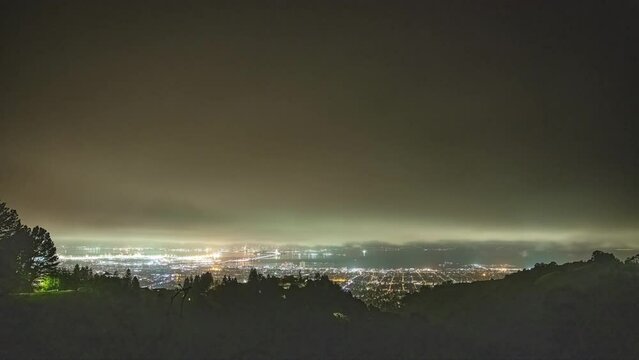 Timelapse shot over San Francisco alongside Oakland Bay Bridge in San Francisco, USA at night time.