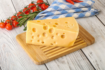 Maasdam cheese piece over board