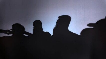 Silhouetted Crowd at Sunset: A romantic scene of love and excitement, as people gather under the evening sky, captured in a striking silhouette against the setting sun