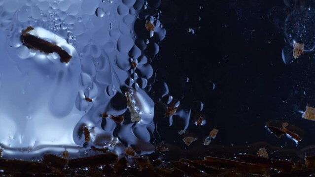 Close-up of Ice cold oily liquid with cell like bubbles moving calmly. Static background.