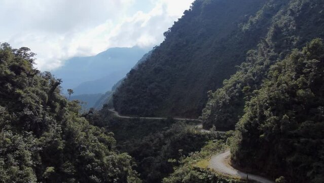 Aerial follows 'Death Road' Yungas in steep Bolivian Andes mountains