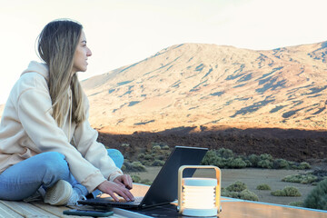 Woman Sitting on Table With Laptop in Front of Teide Mountain © NOWRA photography