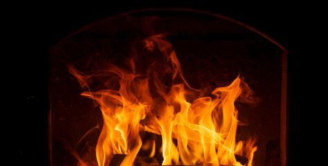 Fire in a stove or fireplace on a dark background isolate