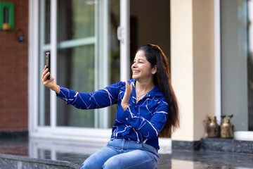 Woman doing video conference using mobile phone