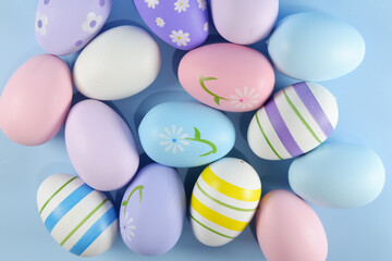 Fototapeta na wymiar Colorful Easter eggs on light blue backgrounds copy space stock photo