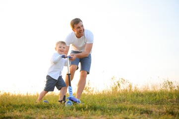 Father's day. Happy family father and toddler son playing and laughing on nature at sunset