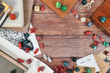 Tabletop role playing flat lay background with colorful RPG dices, rule books and notes on wooden...