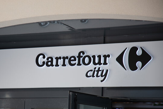 Carrefour city brand logo and text sign front facade entrance town store market french shop supermarket