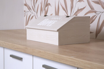 wooden bread box on the kitchen counter	