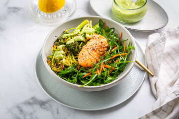 Grilled salmon fillet with parmesan broccoli and fresh vegetable salad, avocado dressing