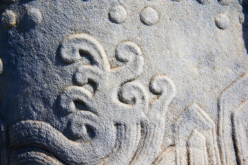 Vintage ornament on the stone. Close-up seamless texture. Stone texture. Embossed pattern.